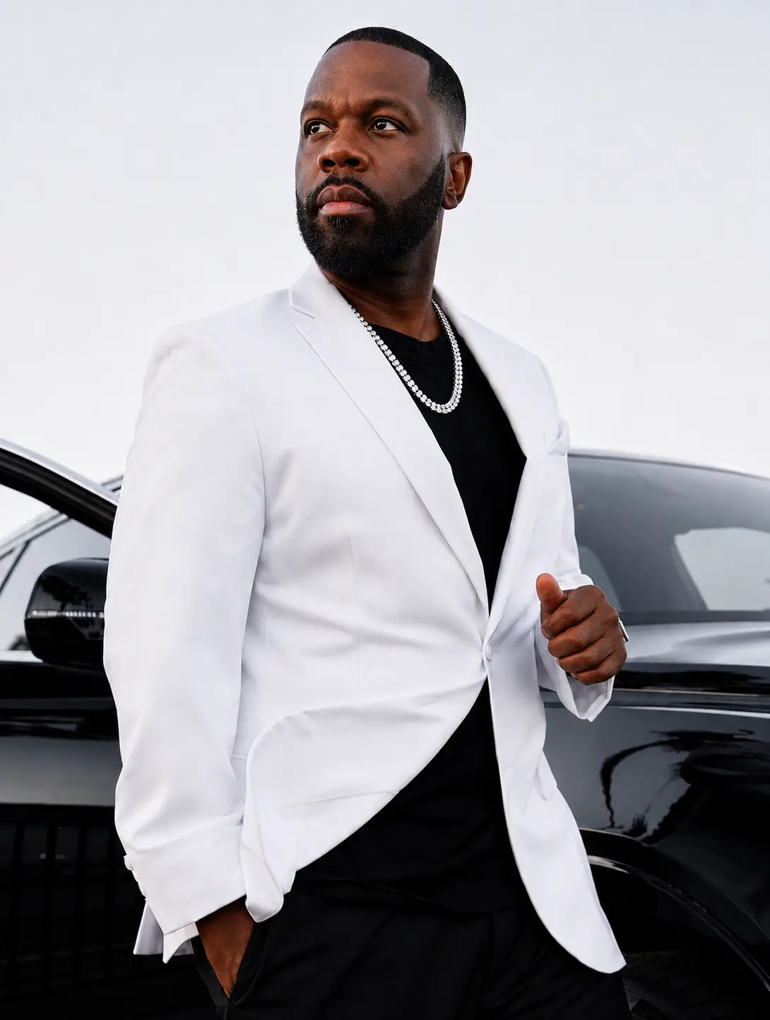 Antoine Sallis standing beside a black luxury car